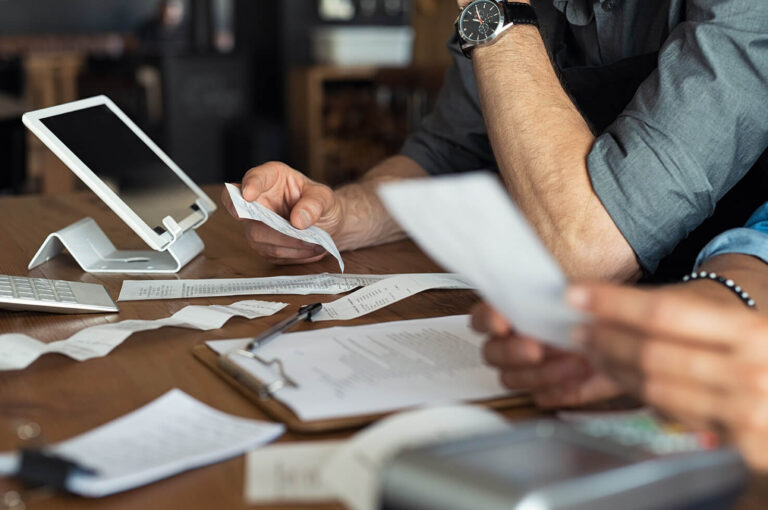 Business owners calculating their full expenses